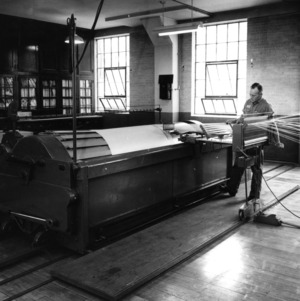 Fred Watkins, lab technician, with machinery in Tompkins Hall