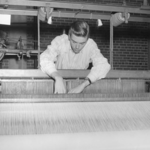 Student using a textile machine