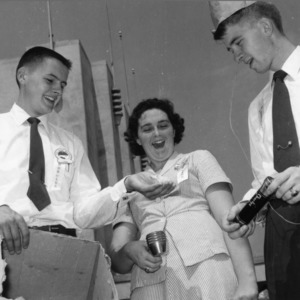 Left to right, Kenneth Howe, unidentified woman, and Charles Canada laughing at the North Carolina 4-H Honor Club Conference
