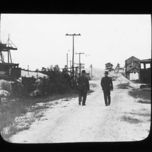 Two men standing by phosphate mine