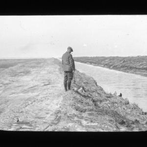 Man standing next to a new ditch in a bog