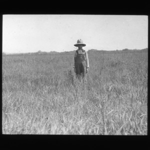 Grassland with boy in straw hat