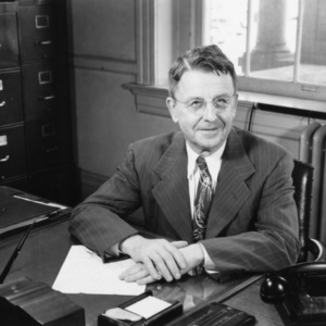 Zeno P. Metcalf at desk