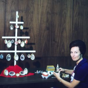 Woman participating in an arts and crafts fair (styrofoam eggs)