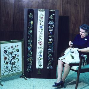 Woman participating in an arts and crafts fair (needle stitch)