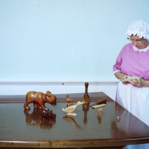 Woman participating in an arts and crafts fair (wood carvings)
