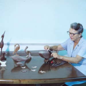 Woman participating in arts and crafts fair (wood figures)
