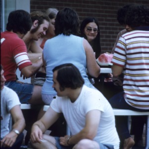 A group of young people eating watermelon