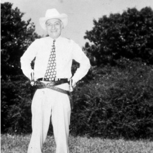 L. R. Harrill wearing cowboy boots and holsters