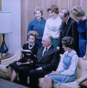 4-H members showing a book to an older man