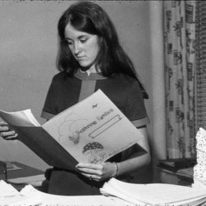 A young woman looking at a beginning families pamphlet
