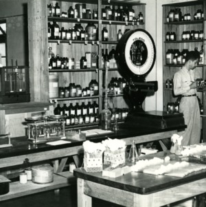 Man in a lab with scale and chemicals