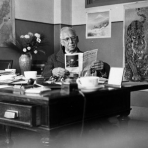 C. D. Hart reading at desk