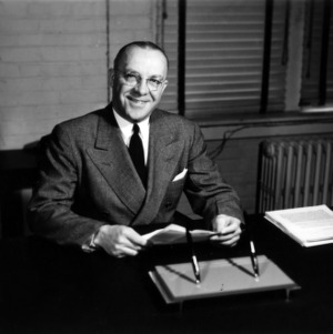 Dean James H. Hilton at desk