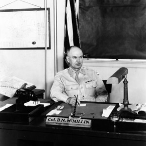 Colonel D. N. McMillin at desk