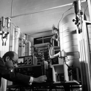 Fred Smetana examining resolution vacuum gauge calibration machinery