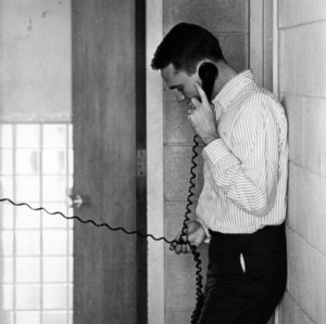 Student using the hall phone