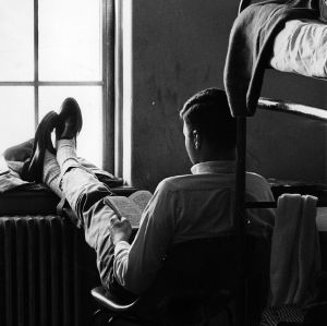 Student reading a book in his dorm room