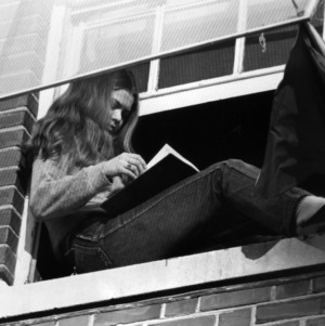 Student reading in her window