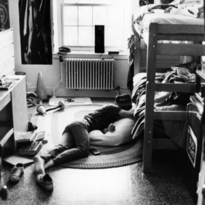 Student sleeping on his dorm room floor at 11:10 am