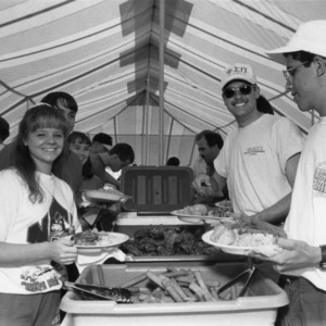 Young alumni at a barbecue