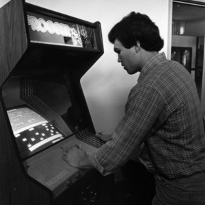 Student playing an arcade game