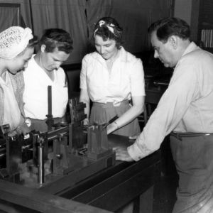 Paul Keirn with girls employed in war production plant