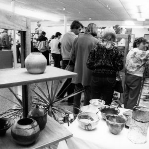 Students and visitors viewing pottery exhibit