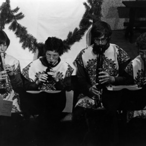 Students playing flutes during Christmas performance