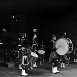 NC State College pipes and drums band performing on stage
