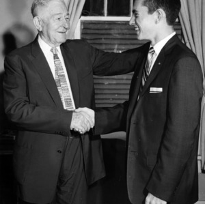 W. J. Mathews shaking the hand of Hubert W. McGee