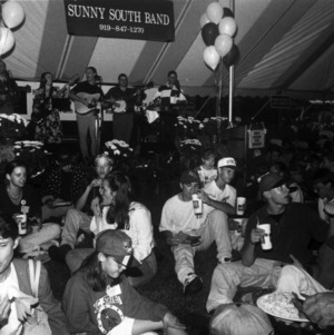 Band and tent at a CALS alumni tailgate event, 1990s