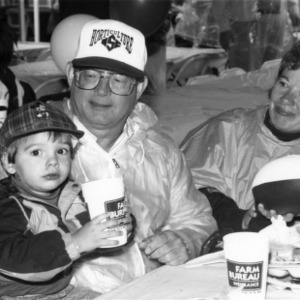 A family at the NC State Alumni Tailgate Event, 1990s