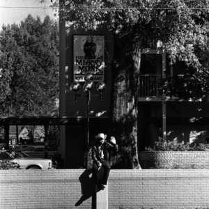 Man watching homecoming parade in from of North Hall, 1976
