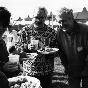 CHASS Dean Toole greets alumni at tailgate event, 1990s