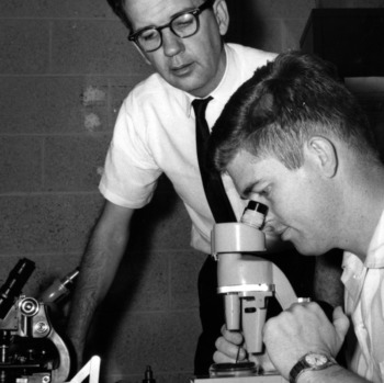 Dr. Robert Aycock and graduate student Joe Fox studying disease specimen submitted to Plant Disease Clinic