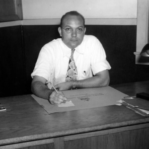 Paul B. Mitchell, director of the Morehead City Technical Institute, at desk