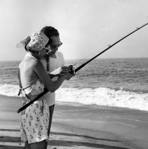 Man and woman fishing on beach