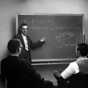 Vander Vaart demonstrating "Statistics Genesis of Knowledge" at blackboard