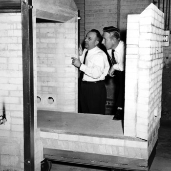 Dr. William C. Bell and Alex Carlyle inspecting shuttle kiln
