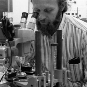 Man using microscope in Electrical Engineering lab