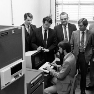 Electrical Engineering group of people standing around computer