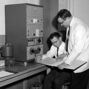 Men using spectrometer counting gamma rays