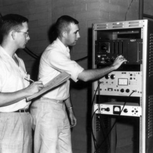 John Paulk and William Leggett with nuclear reactor equipment