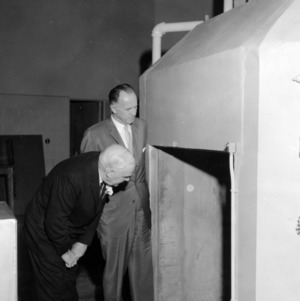 Governor Luther H. Hodges and Walte Hasselhorn, president of Cook Electric Company inspecting reactor on day of critical experiment