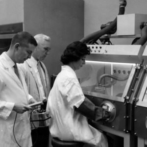 W. Alton Reid, Dr. Alonzo F. Coots, and student conducting experiment in Radiochemistry Laboratory