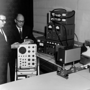 Dr. Megla and other with equipment in lab