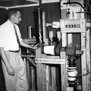 King Brose shown with equipment for studying wood hydrolysis