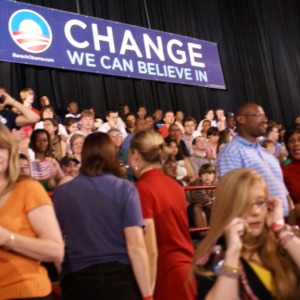 People waiting for Barack Obama to arrive with "Change" banner in the background