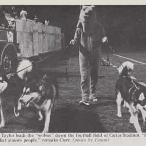 Cleve Taylor and live dog mascots in Carter Stadium (Technician, Vol. 53 No. 59, February 21, 1973)